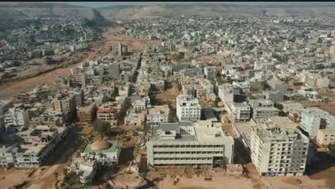 DERNA — a wide aerial frame of the city of Derna stretching toward the coast