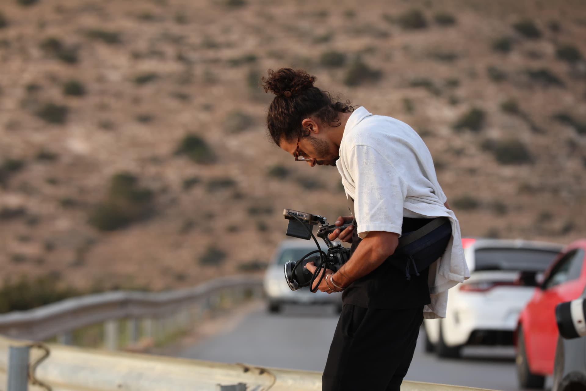 Asaad filming on location among the hills