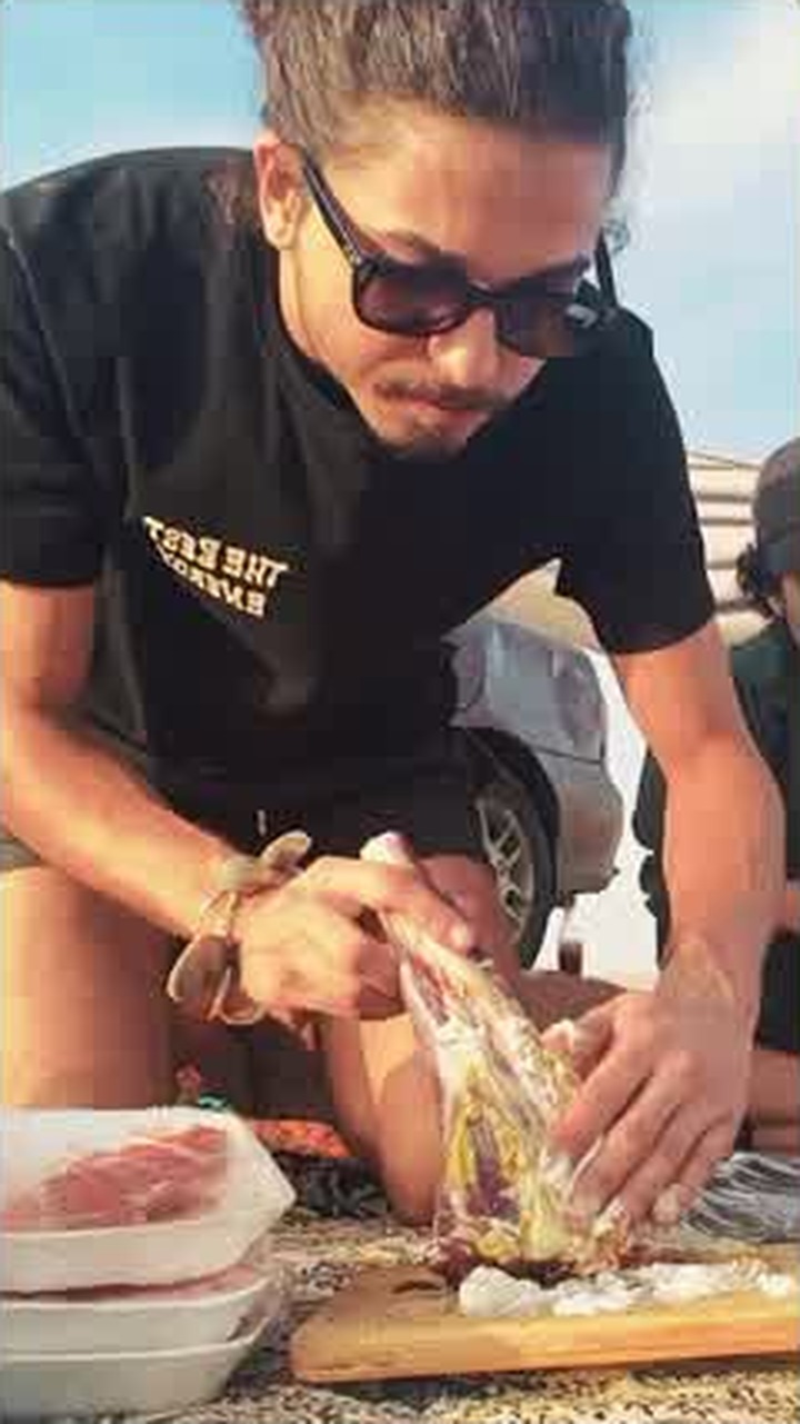 Asaad preparing food outdoors with his hands