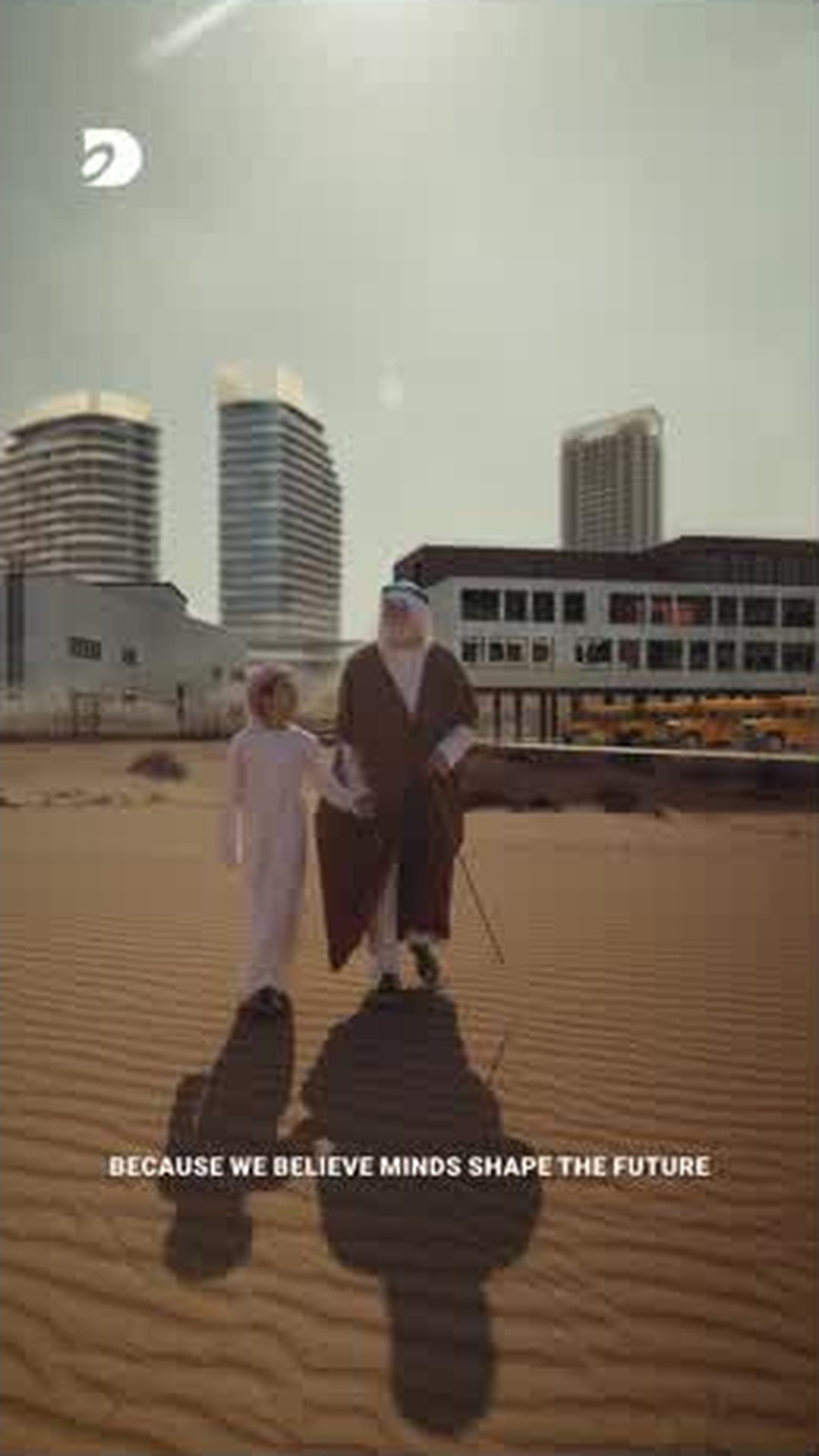 The child and the elder walking past a school building in the sand
