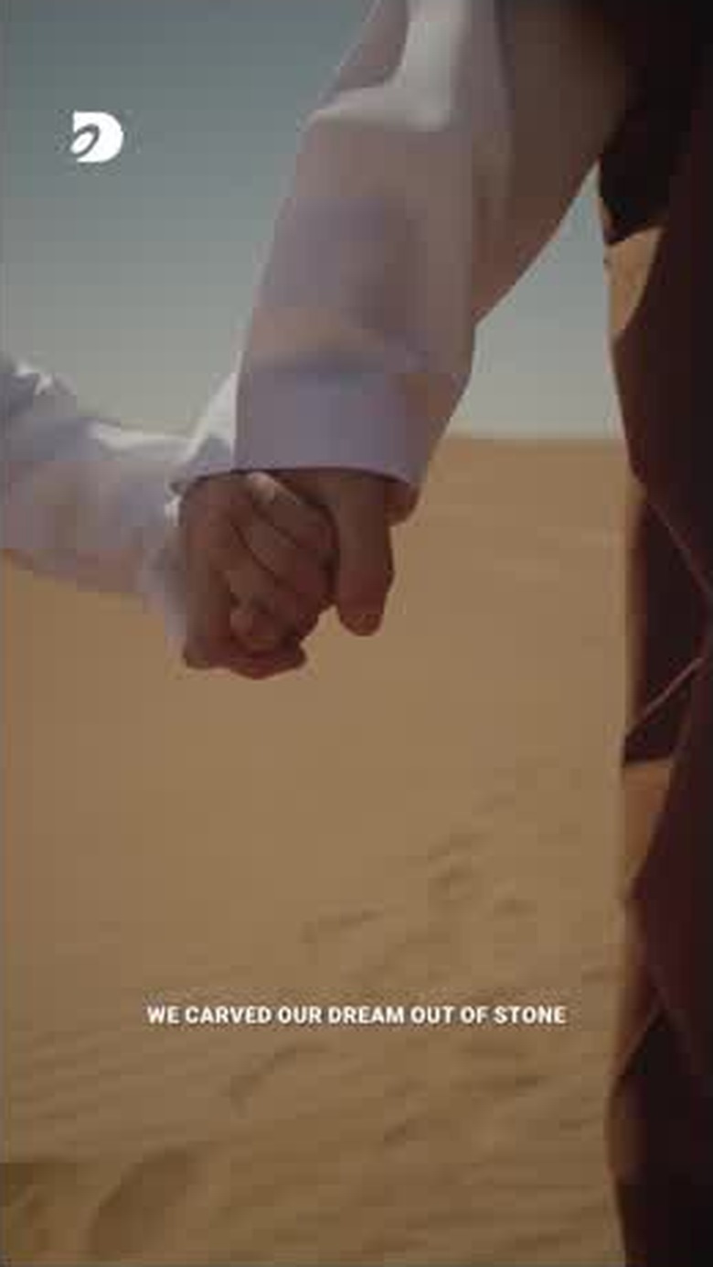 An older hand holding a child's hand, close on the desert walk
