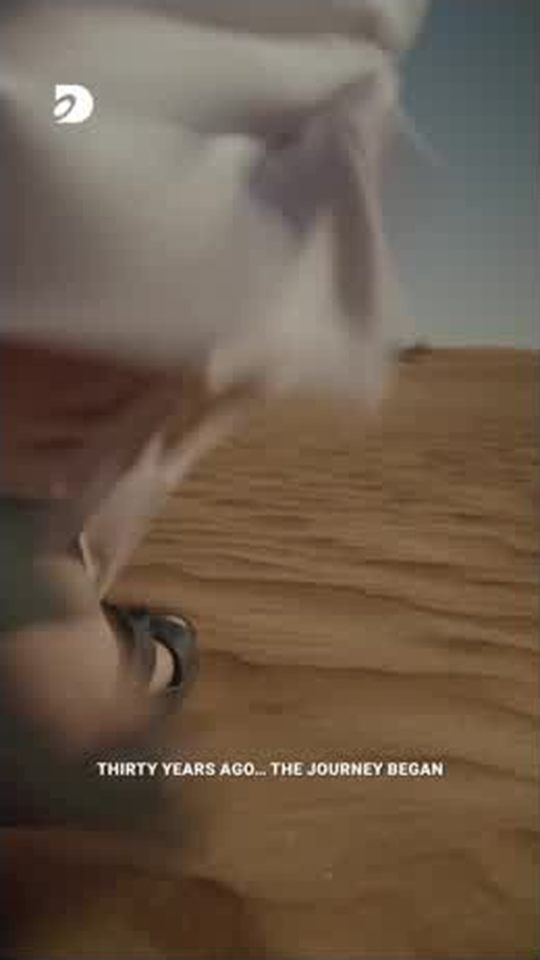 First steps across the sand — the opening frame of the film