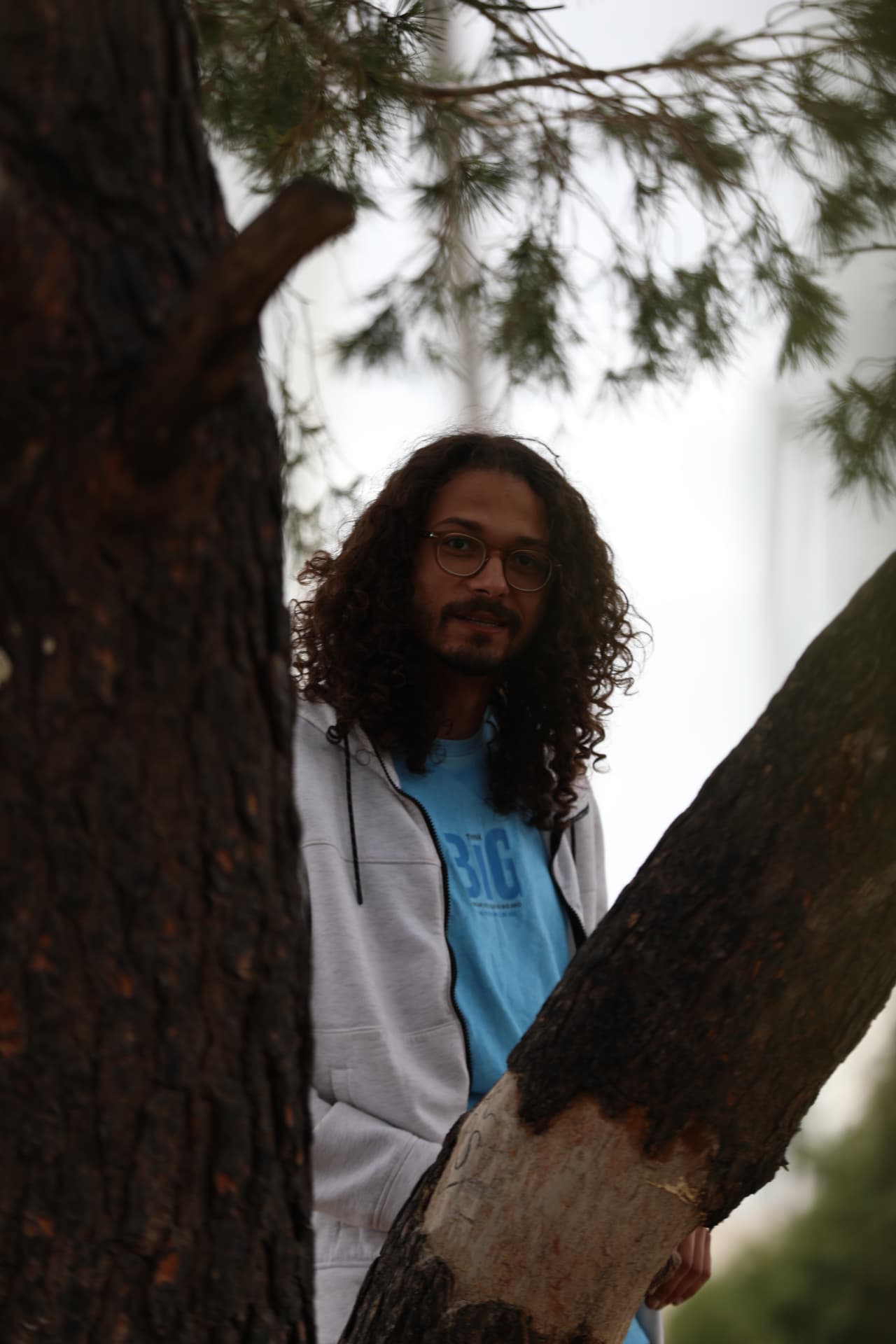 Portrait on location in Derna, Libya, framed between pine branches
