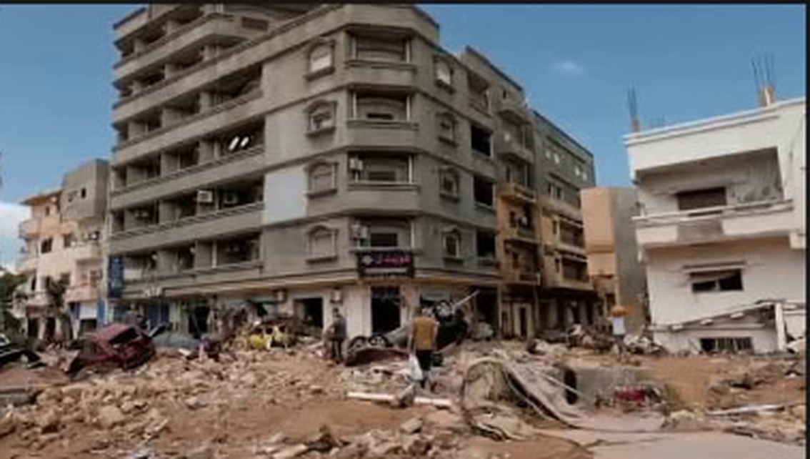 A damaged residential building on a street corner