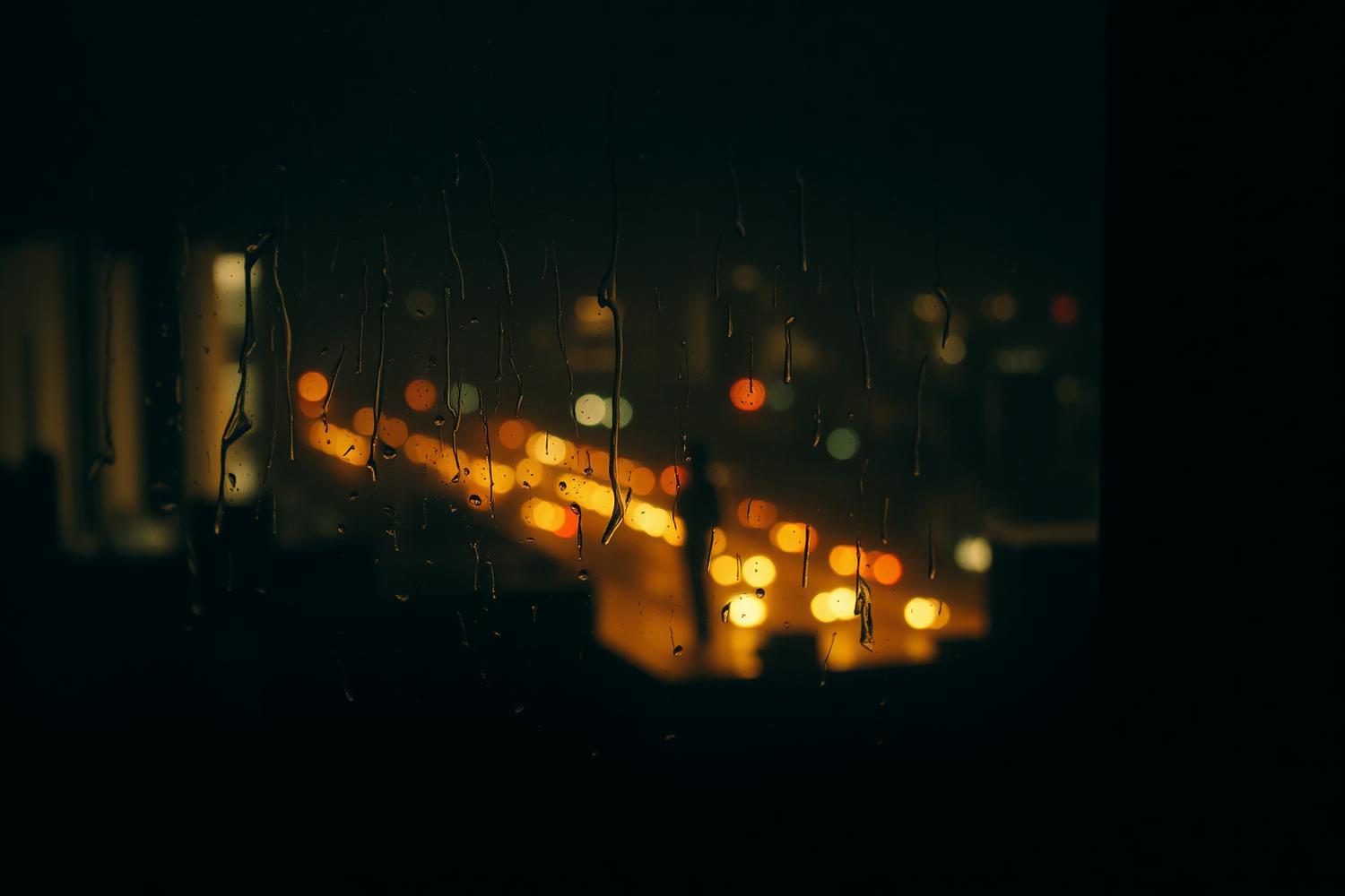 Rain on a window above a night city